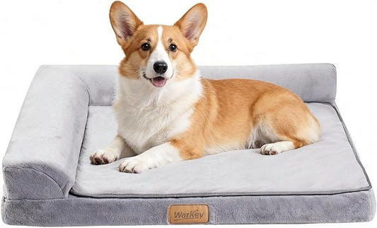 Dog lying on a gray pet bed with a visible brand logo.