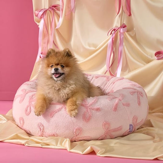 LE SURE Donut Small Dog Bed - Round Cat Beds for Indoor Cats, Washable Calming Pet Beds with Teddy Sherpa Plush & Anti Slip Bottom (Bow Pink Taffy, S Plus (27x27x8))